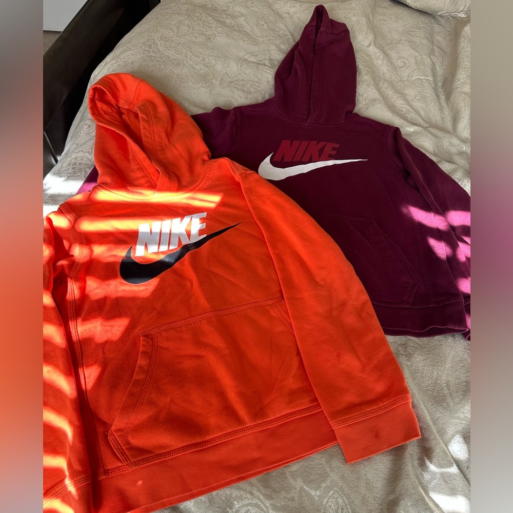 2 Nike hoodies Sz: boys medium , Colors: 1 orange, 1 burgundy. Good condition